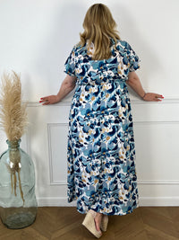 Offrez-vous un look élégant et dynamique avec notre robe longue à motifs Caryn ! Cette robe colorée à motifs est dotée d'un col cache coeur flatteur et de manches courtes pour une allure féminine et confortable. Ajoutez une touche de fraîcheur et de style à votre garde-robe avec cette robe polyvalente.