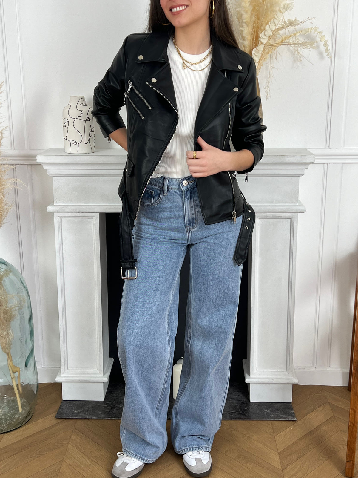 La veste style perfecto noir Cori est la pièce parfaite pour ajouter une touche de style à votre tenue. Avec sa fermeture éclair argentée et sa coupe cintrée, elle apporte une allure moderne et élégante. La ceinture amovible en bas permet d'ajuster la veste à votre goût, offrant confort et style.