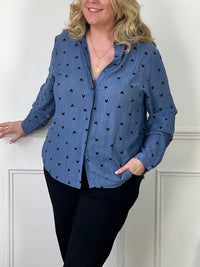 Élégante et confortable, la chemise bleue à cœurs noirs Lana est idéale pour la femme grande taille. Avec des manches longues et un col chemise, elle est boutonnée sur le devant pour un look classique. Les motifs en cœur noir ajoutent une touche de charme.