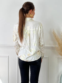 Chemise écrue et détails dorée légère femme Chemise manches longues Boutons sur la longueur Détails motifs brillants dorés Couleur : écru et doré Composition : 100% Viscose Lavage à la main obligatoire Made in P.R.C