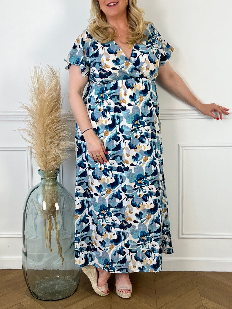 Offrez-vous un look élégant et dynamique avec notre robe longue à motifs Caryn ! Cette robe colorée à motifs est dotée d'un col cache coeur flatteur et de manches courtes pour une allure féminine et confortable. Ajoutez une touche de fraîcheur et de style à votre garde-robe avec cette robe polyvalente.