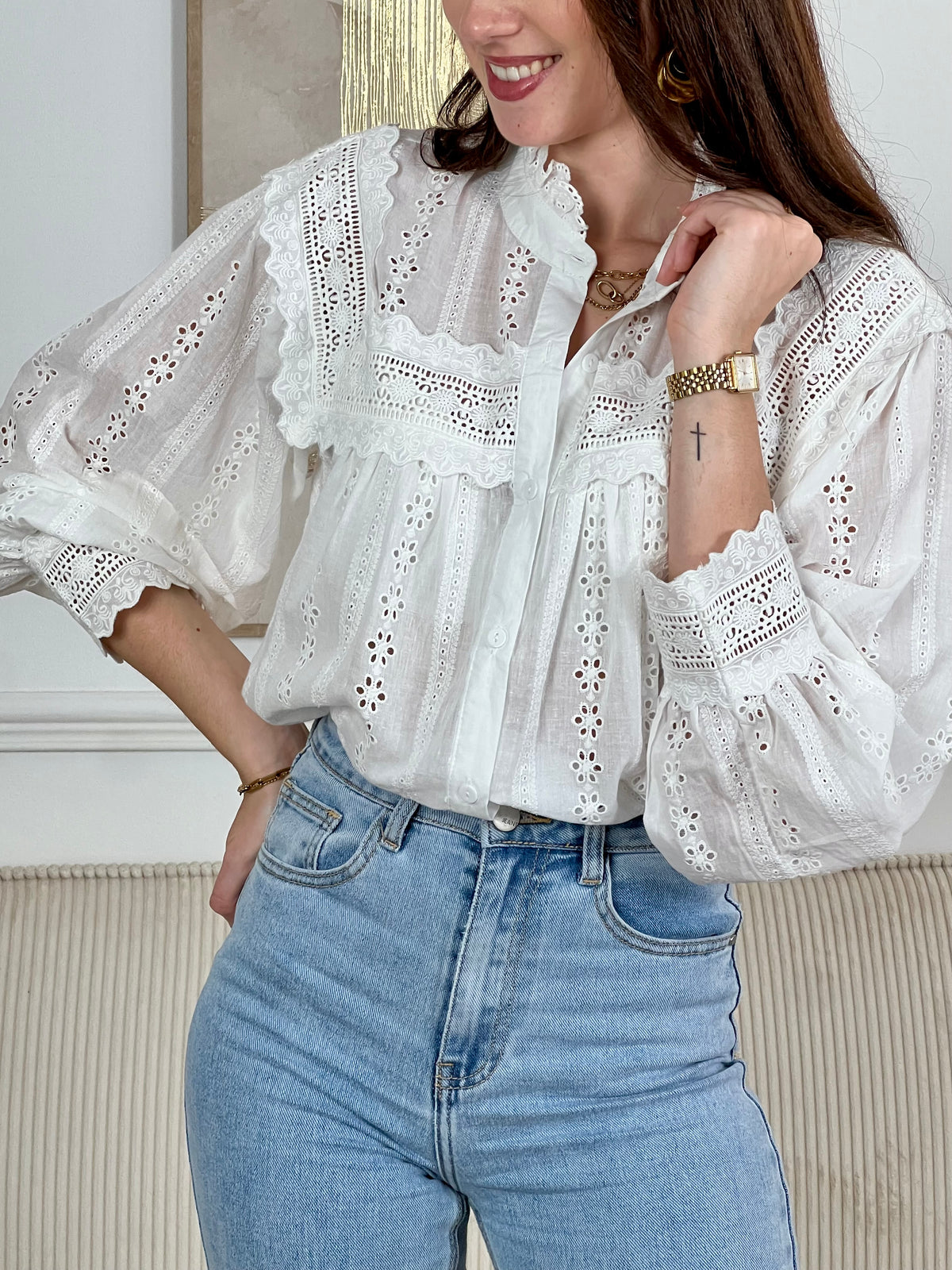 Chemise Angele en coton 100% pour les femmes. Manches bouffantes, col volant et broderie ajourée confèrent à cette pièce écrue une élégance intemporelle. Légèrement transparente, elle se porte avec aisance au quotidien comme en occasion.