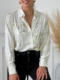 Chemise écrue et détails dorée légère femme Chemise manches longues Boutons sur la longueur Détails motifs brillants dorés Couleur : écru et doré Composition : 100% Viscose Lavage à la main obligatoire Made in P.R.C