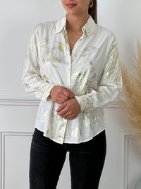 Chemise écrue et détails dorée légère femme Chemise manches longues Boutons sur la longueur Détails motifs brillants dorés Couleur : écru et doré Composition : 100% Viscose Lavage à la main obligatoire Made in P.R.C