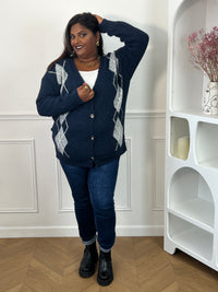 Gilet bleu à losanges porté de face sur un top blanc, avec un jean et des bottines noires – Isadora | Loïcia