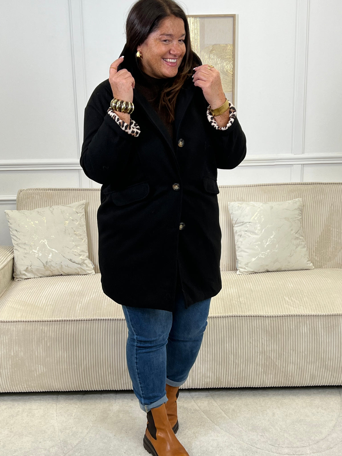 Découvrez notre manteau mi-long noir élégant et tendance, orné de détails léopards sur la capuche et les manches. Pratique et confortable, il dispose de deux poches à l’avant et de boutons sur toute la longueur. Avec sa capuche et son style raffiné, il allie chaleur, originalité et modernité pour un look unique en toute saison.
