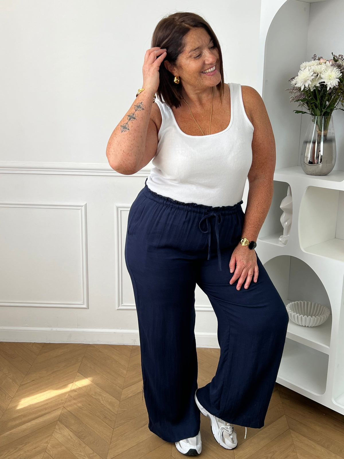 Optez pour ce pantalon élastique grande taille femme à coupe droite, alliant confort et style. Sa taille élastiquée avec lien à nouer assure un ajustement parfait. En bleu marine, il s’adapte facilement à toutes vos tenues du quotidien.