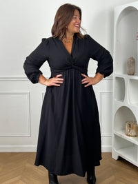 Femme grande taille portant la robe portefeuille noire Cassiope – Col cache-cœur, tailles 42/44 à 52/54 | Loïcia