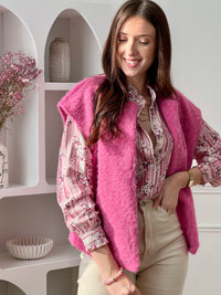 Adoptez cette veste sans manches femme, simple et tendance. Dotée d’un col rond, elle est idéale pour superposer vos tenues avec style. Sa couleur rose apporte une touche douce et féminine à votre look.