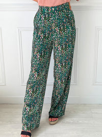 PANTALON FLUIDE FEMME À MOTIFS Pantalon fluide Élastique au dos Passants pour ceinture Fermeture éclair et bouton Couleurs : bleu, vert, rose et écru 2 poches latérales Composition : 100% Polyester